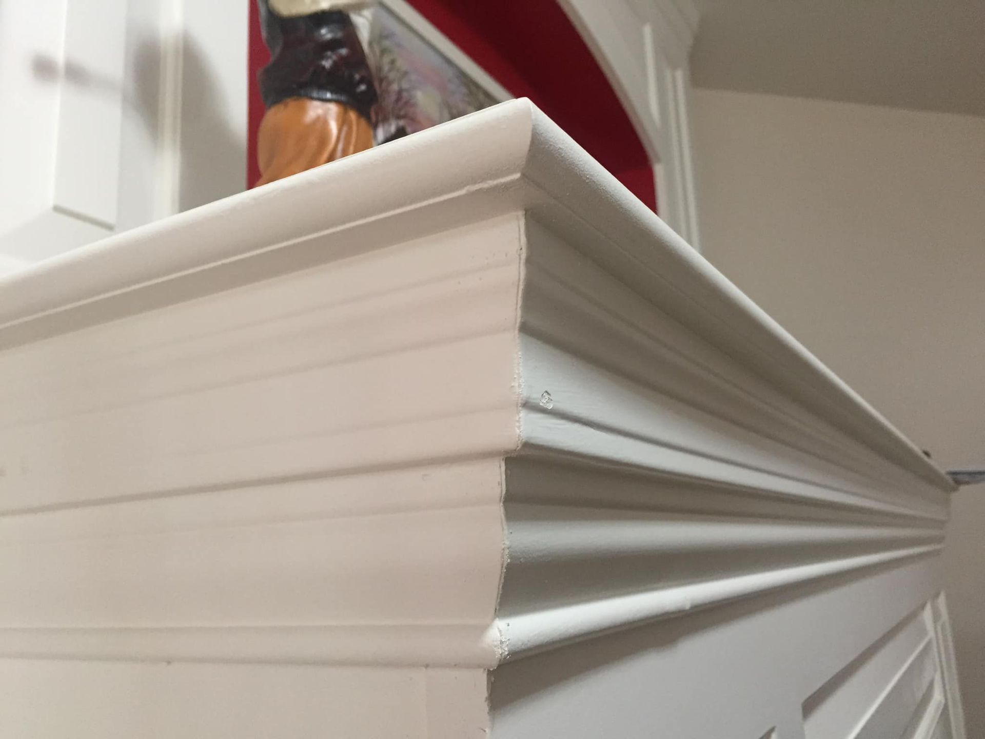 White fireplace mantel with layered trim detail.