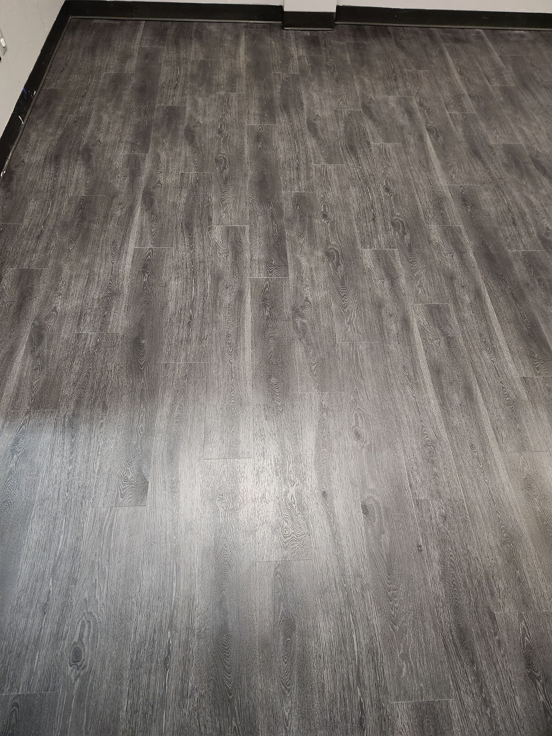 Empty gray carpeted floor in a room, viewed from above