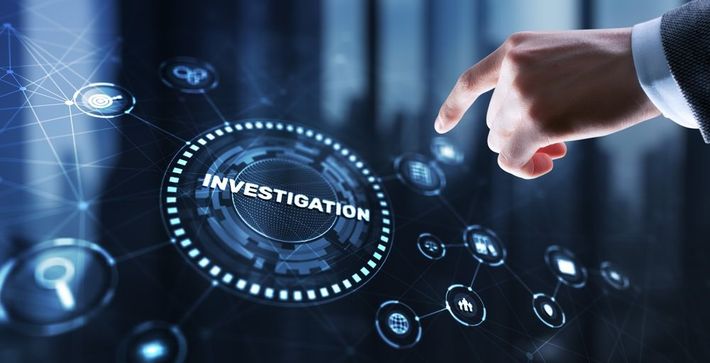 Hand pointing at a glowing digital interface labeled “INVESTIGATION” with connected icons