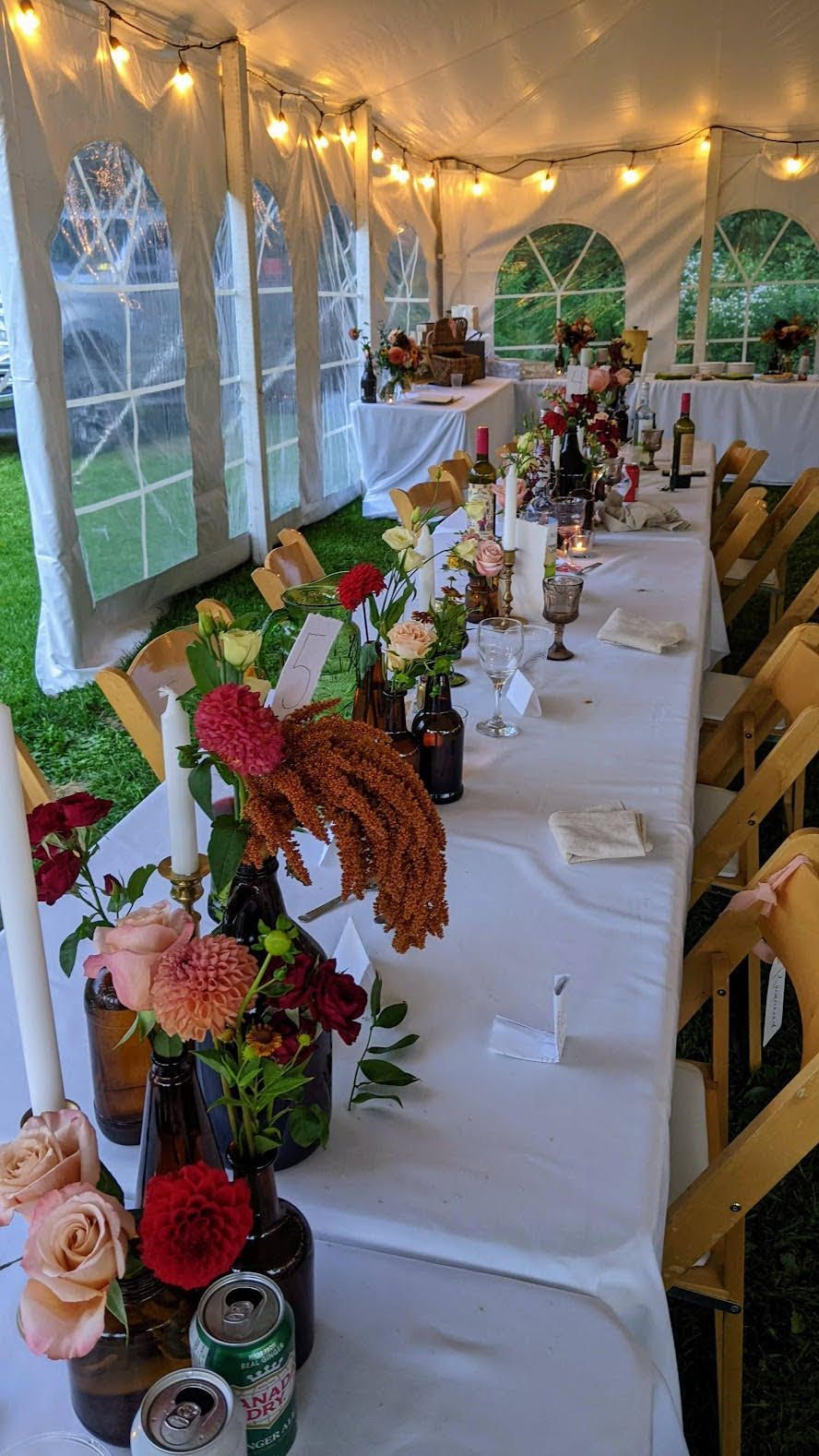 a long table with flowers and a can of sierra mist on it