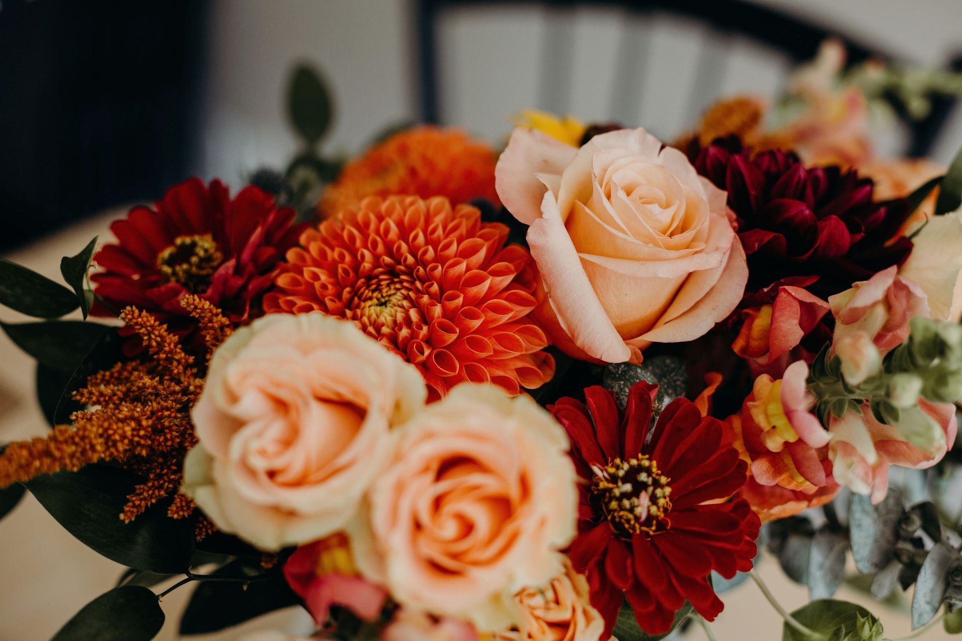 a bouquet of flowers including roses and dahlias