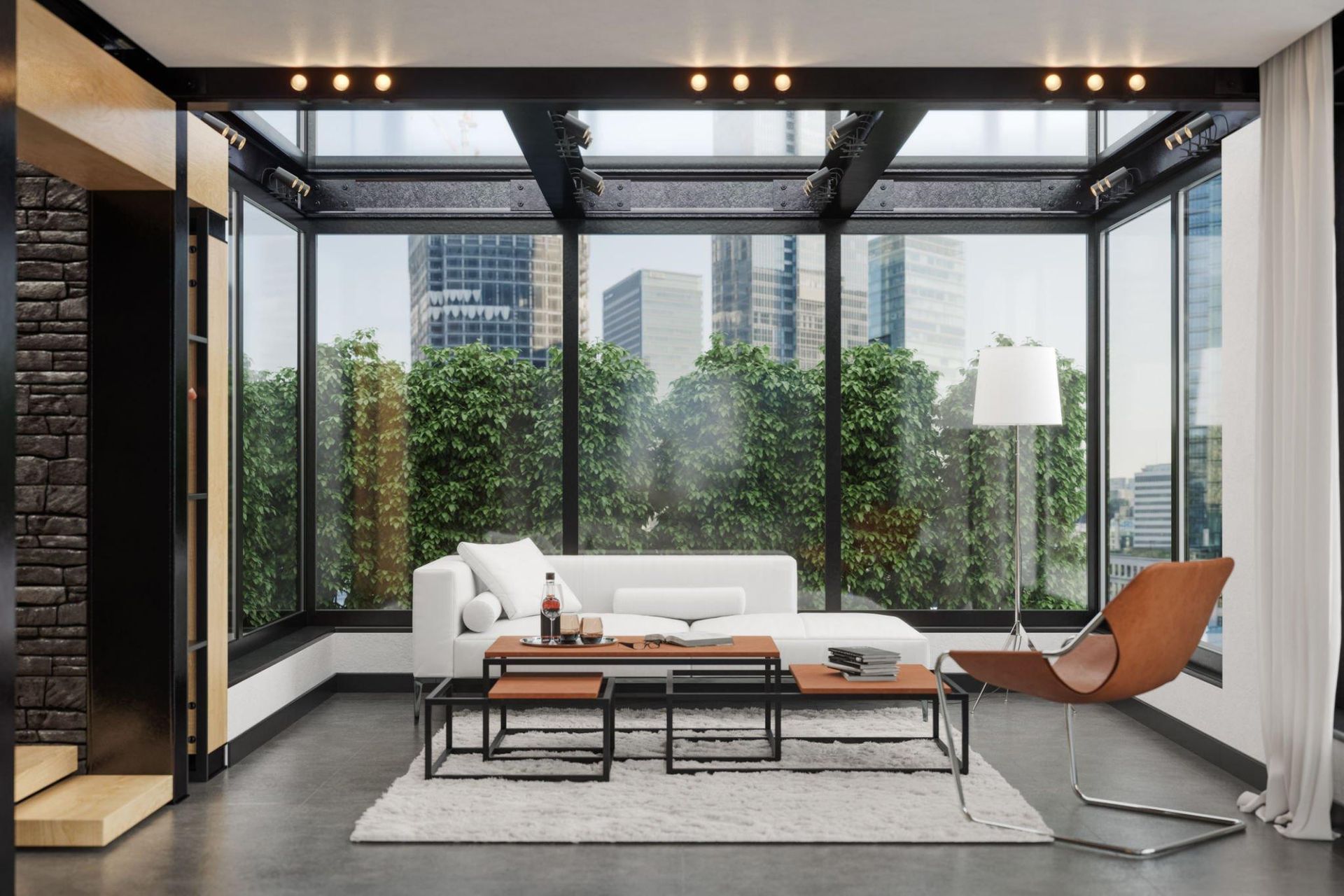 A living room with a couch , chair , coffee table and lots of windows.