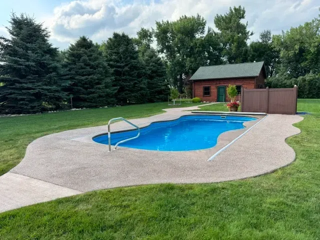 swimming pool with a concrete patio deck