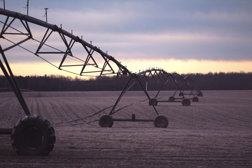 A water irrigation system set up in a field of crops A water irrigation system set up in a field of crops