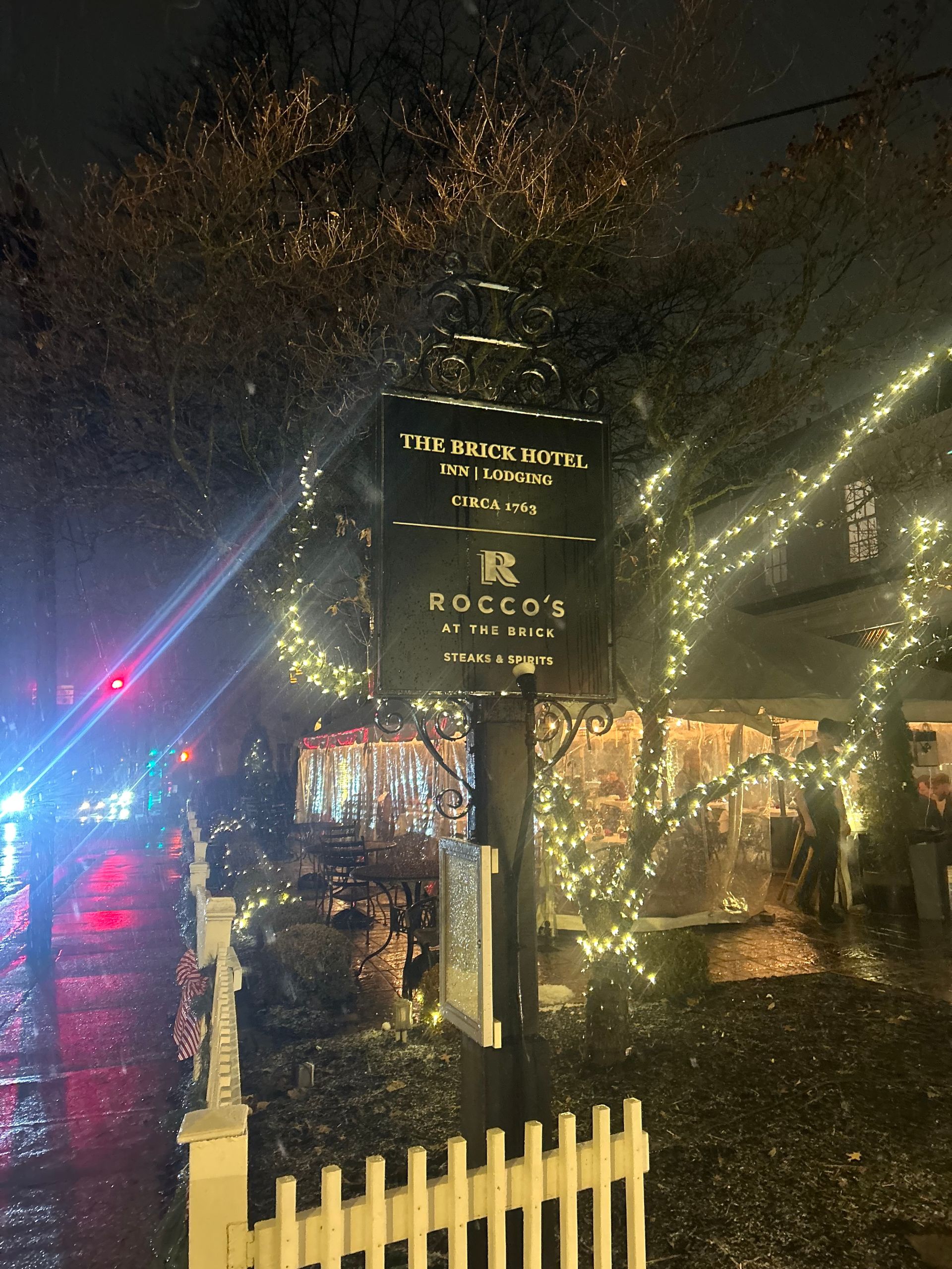 Sign for Rocco's on the beach lit up with lights at night.