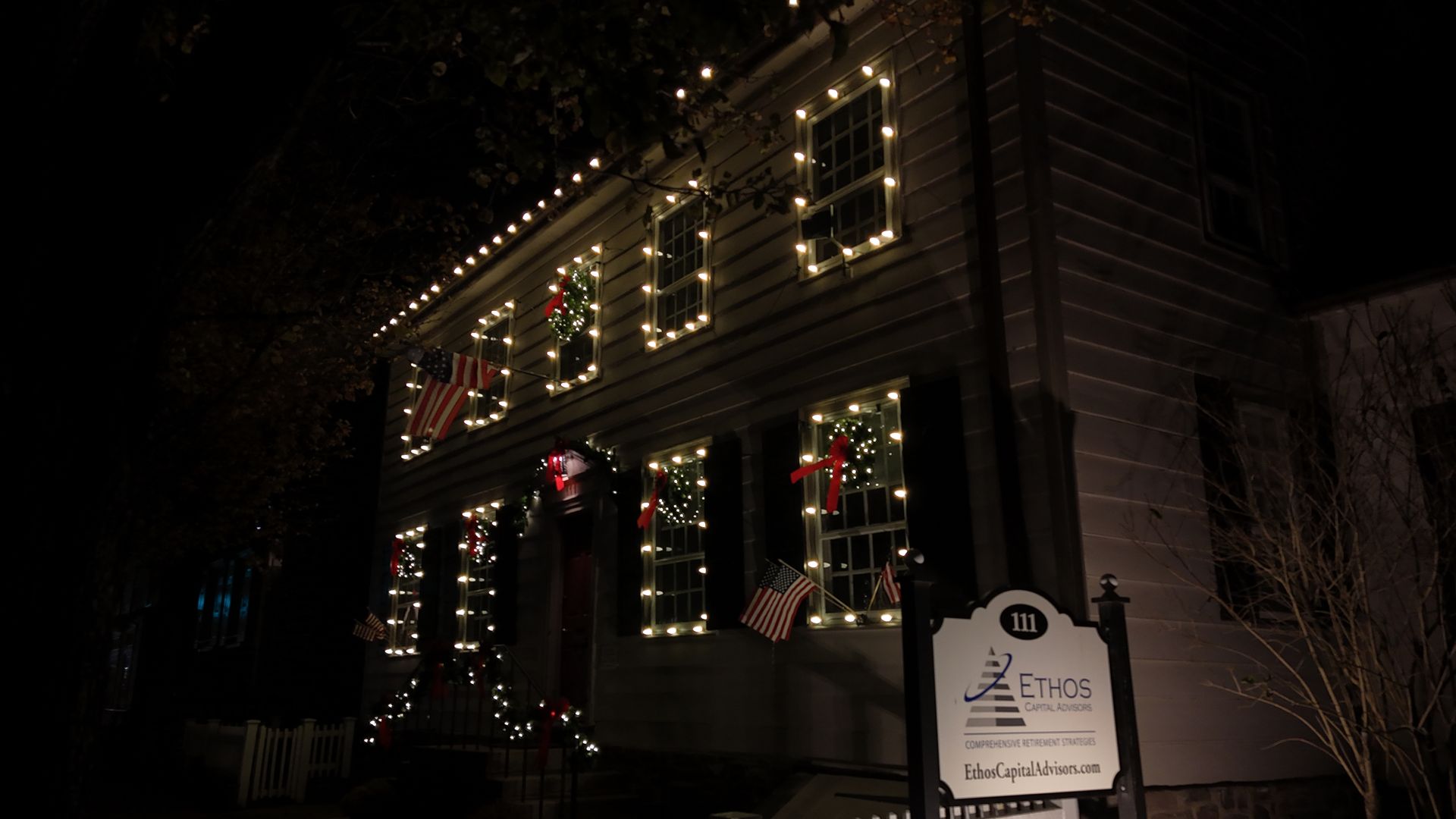 Historic building at night with Christmas lights.