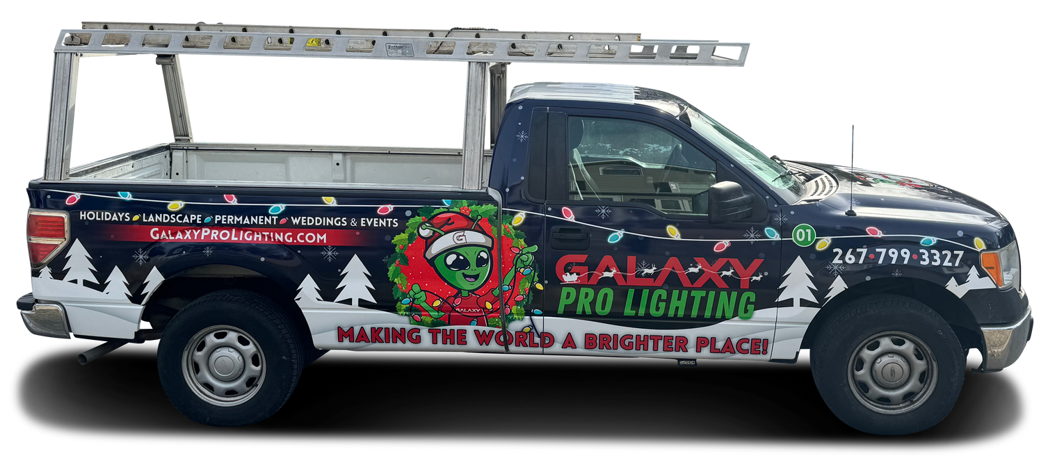 Galaxy Pro Lighting truck with ladder rack and Christmas themed graphics.