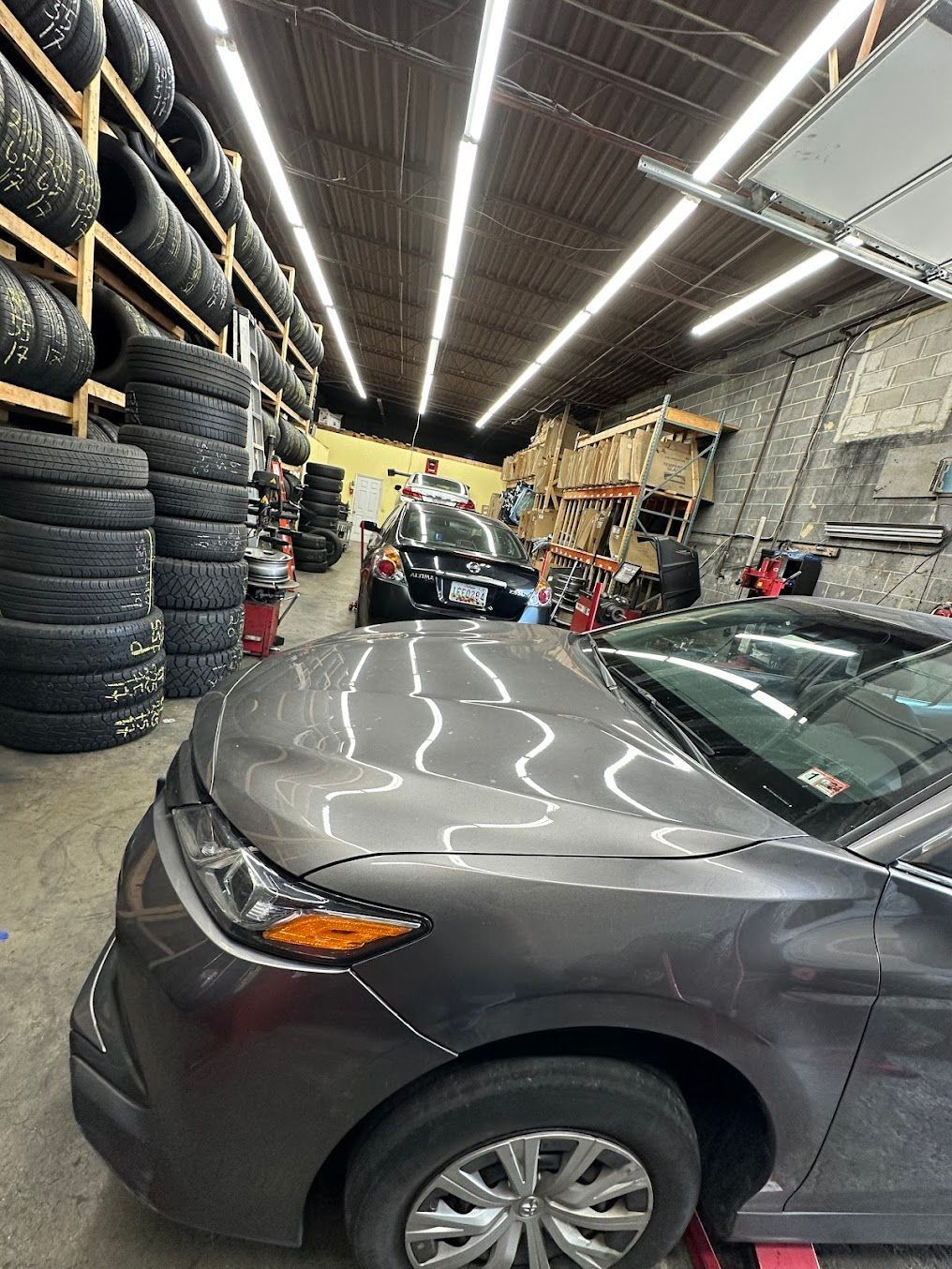 A gray car parked inside an auto shop | Rockville New and Used Tires
