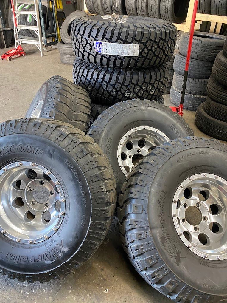 Stacked off-road tires and wheels in a garage or tire shop | Rockville New and Used Tires