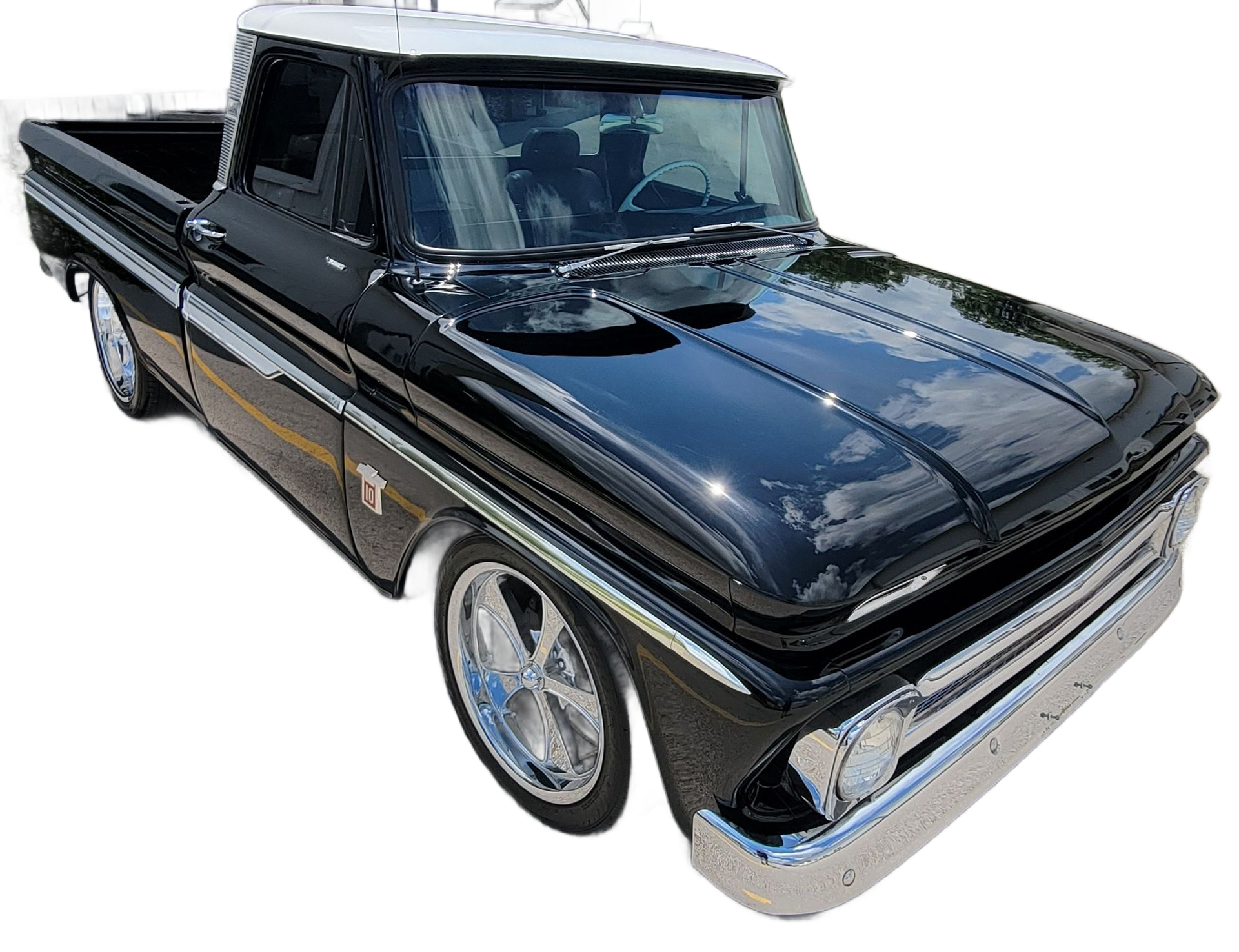 Black classic pickup truck with chrome trim and white roof, shown in side view.
