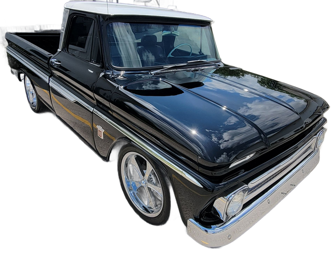 Black classic pickup truck with chrome trim and white roof, shown in side view.