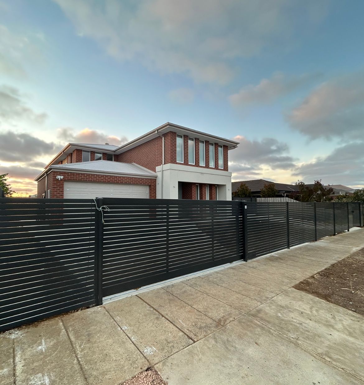 A large house with a black fence in front of it.  — Talking Fences In Portarlington, VIC