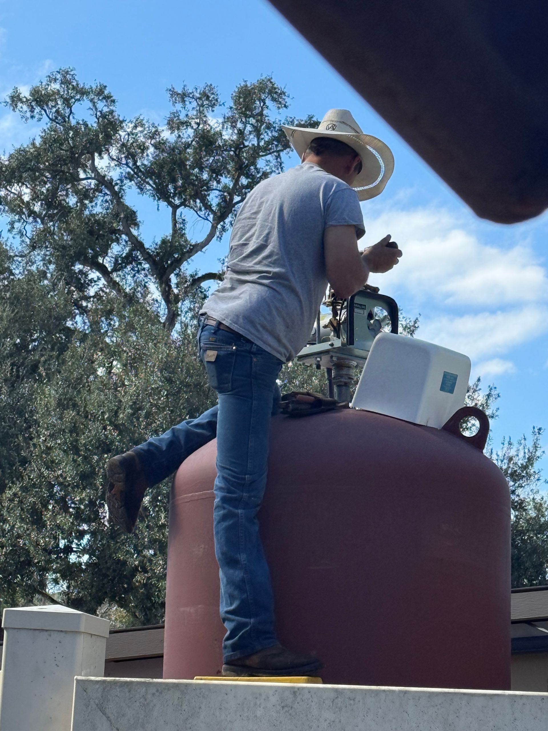 Charlie servicing a pressure tank in the field.