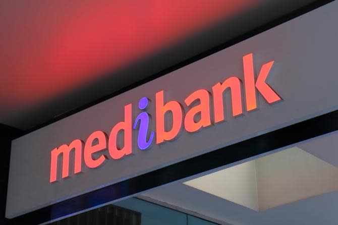 A medibang sign is lit up in red and blue