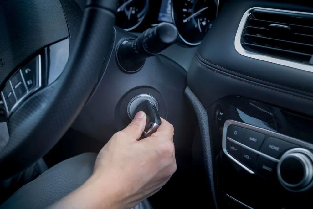 Hand Inserting Car Key Into Ignition, Starting a Vehicle — Edmonton Battery Centre in Bentley Park, QLD