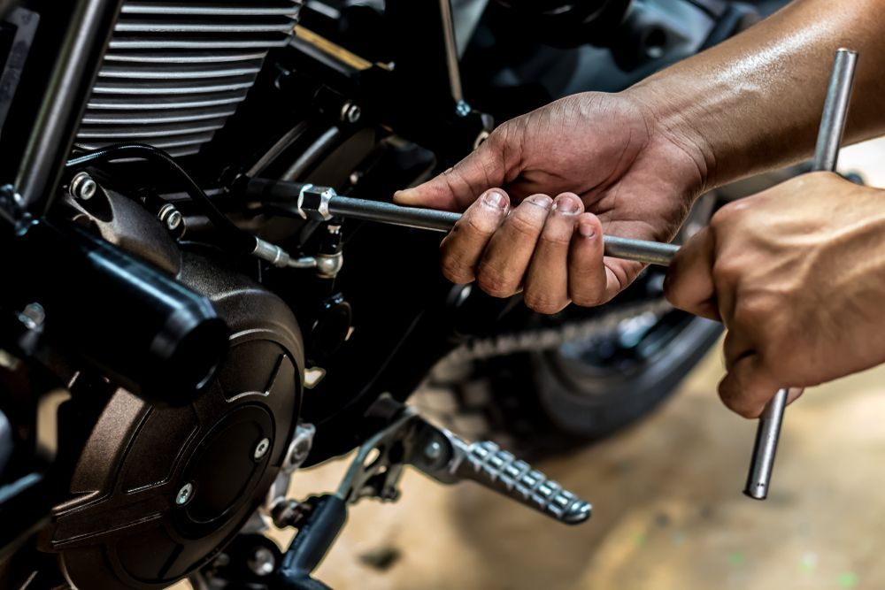 Hands Using a Wrench to Repair a Motorcycle Engine Close-up — Edmonton Battery Centre in Edmonton, QLD