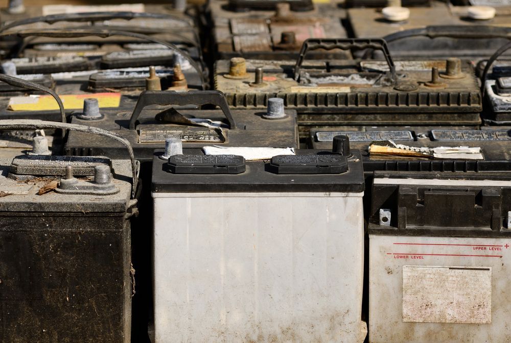 Rows of Old Car Batteries With Corroded Terminals and Worn Labels in a Workshop — Edmonton Battery Centre in Earlville, QLD