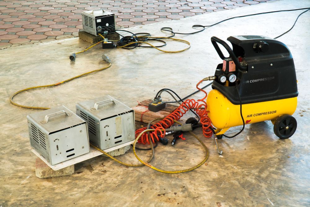Three Power Units and Tangled Cables on a Wet Concrete Floor — Edmonton Battery Centre in Gordonvale, QLD