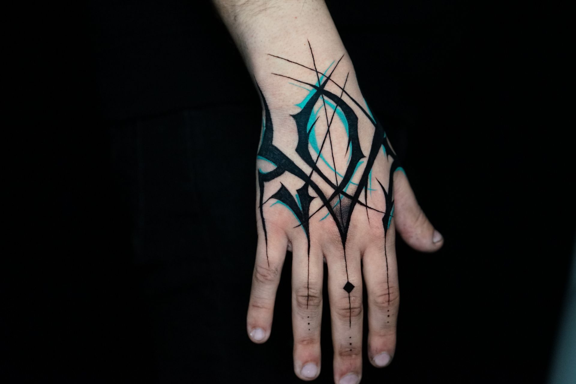 A close up of a person 's hand with a tattoo on it.