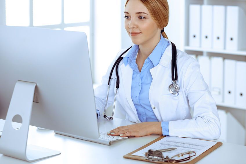 nurse typing on computer