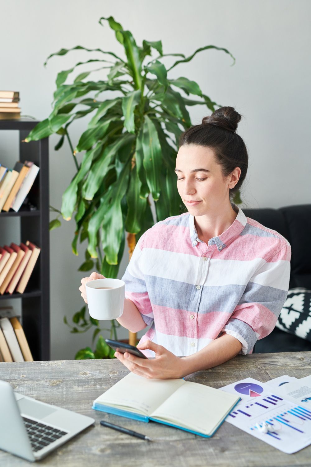 A woman is writing on a clipboard with a pen.