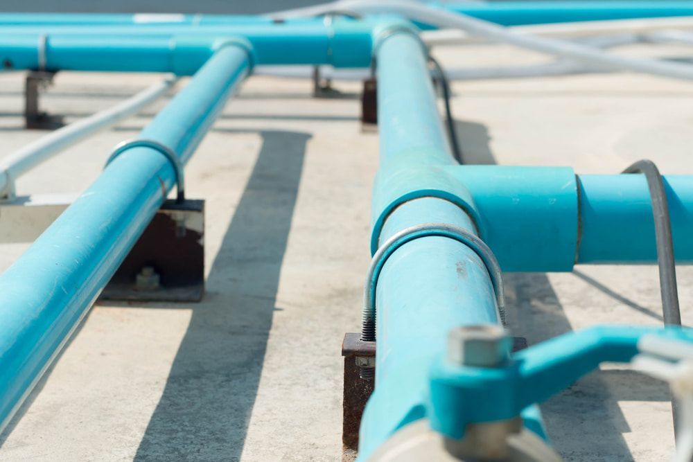 Bunch of Blue Pipes Are Connected to Each Other on the Ground — Off-Tap Plumbing NQ In Currajong, QLD