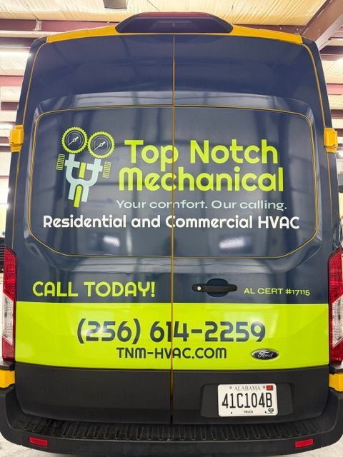Yellow and black Top Notch Mechanical HVAC van with company logo, phone number, and service text on back windows