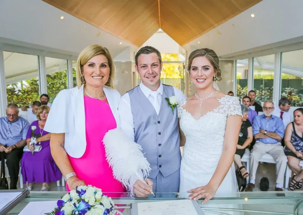 A Bride and Groom Are Posing for a Picture With Their Mother โ GinaS Cairns Tropical Weddings in Parramatta Park, QLD