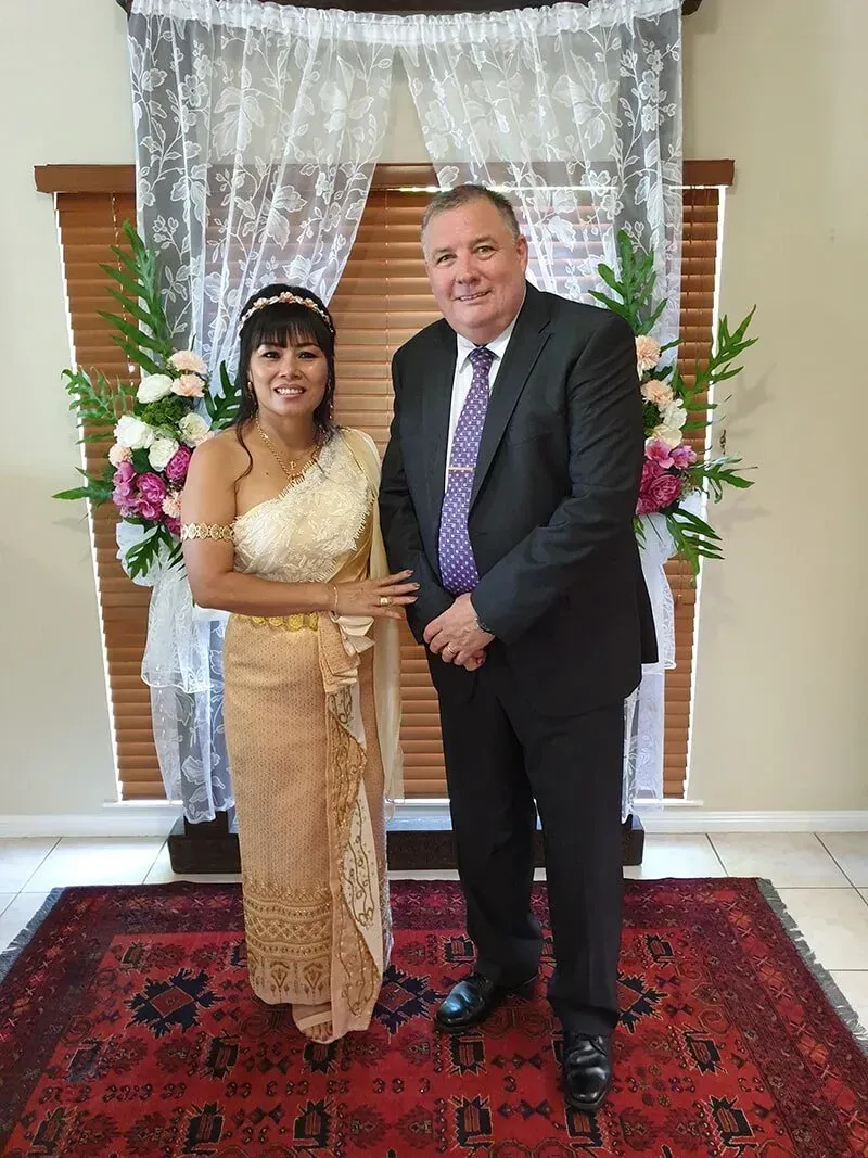A Man in a Suit is Standing Next to a Woman in a Wedding Dress โ GinaS Cairns Tropical Weddings in Parramatta Park, QLD