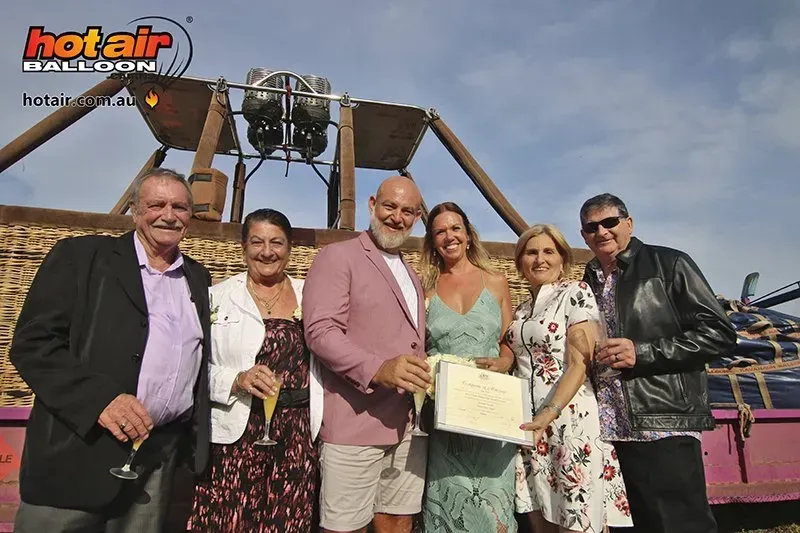 A Group of People Standing in Front of a Hot Air Balloon โ GinaS Cairns Tropical Weddings in Parramatta Park, QLD