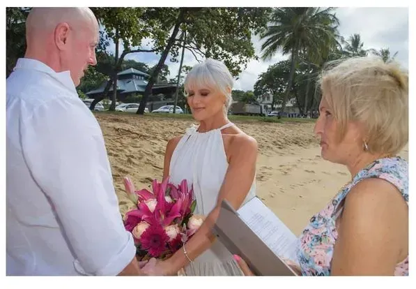 A Man and Woman Are Holding Hands During a Wedding Ceremony โ GinaS Cairns Tropical Weddings in Parramatta Park, QLD