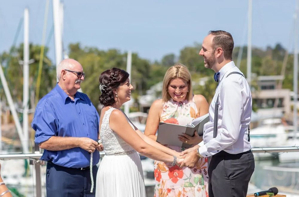 A Bride and Groom Are Holding Hands During Their Wedding Ceremony โ GinaS Cairns Tropical Weddings in Parramatta Park, QLD