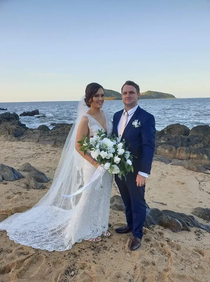 A Bride and Groom Are Posing for a Picture on the Beach โ GinaS Cairns Tropical Weddings in Parramatta Park, QLD