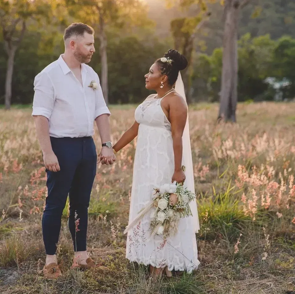 A Bride and Groom Are Holding Hands in a Field โ GinaS Cairns Tropical Weddings in Parramatta Park, QLD