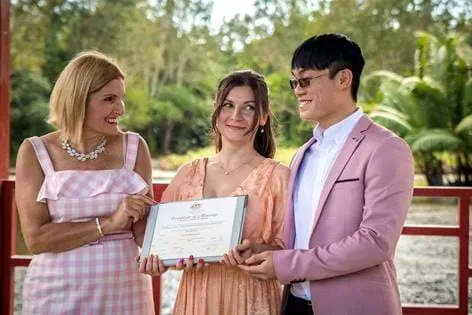 A Man and Two Women Next to Each Other Holding a Certificate โ GinaS Cairns Tropical Weddings in Parramatta Park, QLD