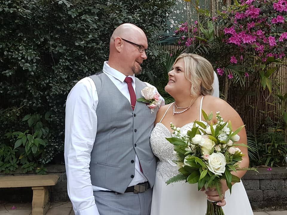 A Bride and Groom Are Posing for a Picture on Their Wedding Day โ GinaS Cairns Tropical Weddings in Parramatta Park, QLD