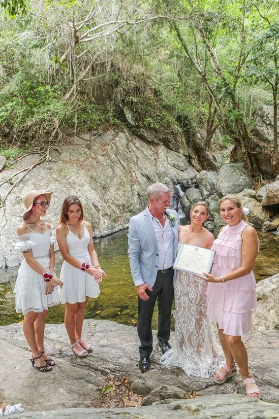A Bride and Groom Are Posing for a Picture With Their Wedding โ GinaS Cairns Tropical Weddings in Parramatta Park, QLD
