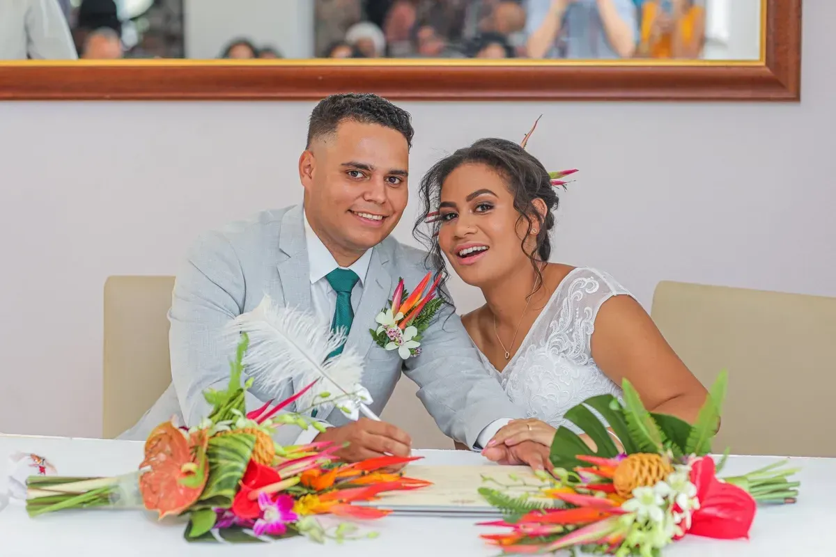 A Bride and Groom Are Sitting at a Table With Flowers โ GinaS Cairns Tropical Weddings in Parramatta Park, QLD