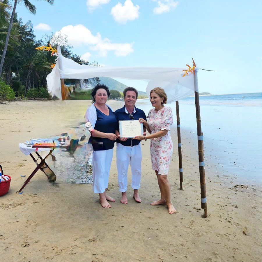 Couple with Cairns marriage celebrant at beach wedding