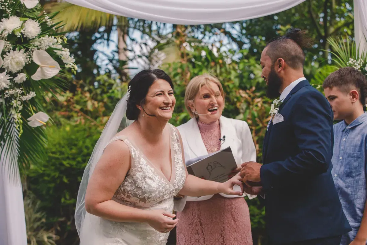 A Bride and Groom Are Holding Hands During Their Wedding Ceremony โ GinaS Cairns Tropical Weddings in Parramatta Park, QLD