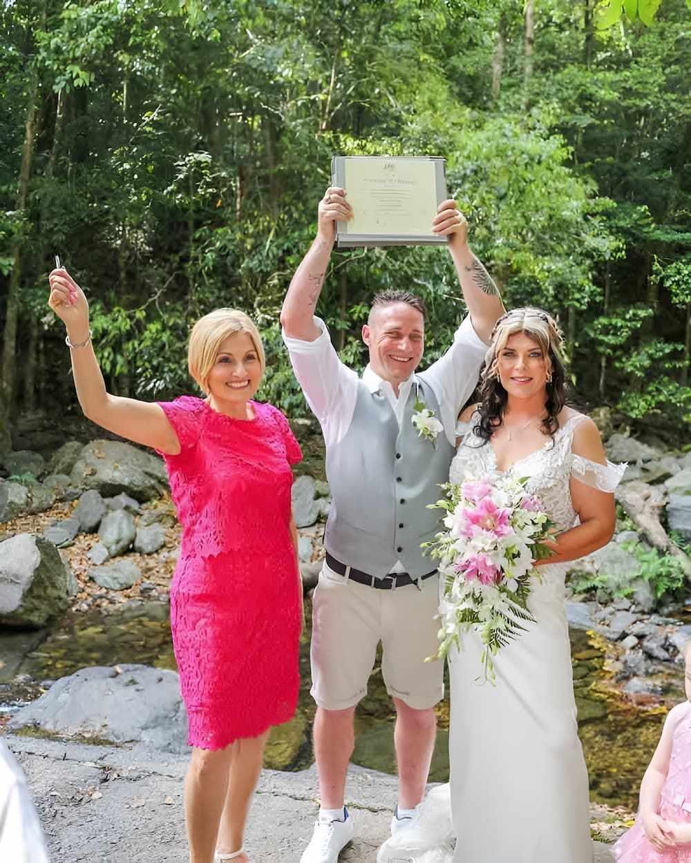 A Bride and Groom Are Standing Holding a Certificate — GinaS Cairns Tropical Weddings in Parramatta Park, QLD