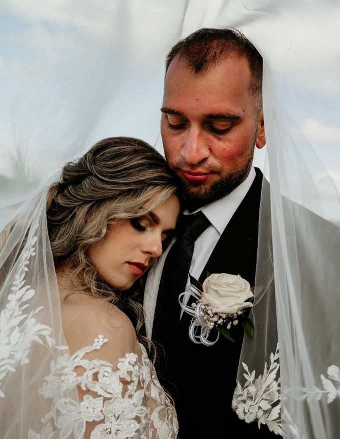 Bride and groom embracing beneath a sheer white veil — GinaS Cairns Tropical Weddings in Parramatta Park, QLD