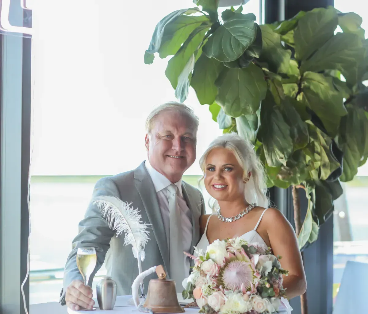 A Bride and Groom Are Posing for a Picture at Their Wedding โ GinaS Cairns Tropical Weddings in Parramatta Park, QLD