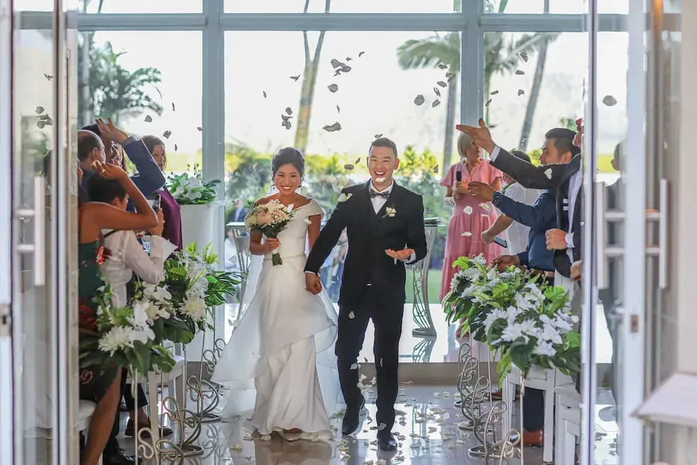A Bride and Groom Are Walking Down the Aisle at Their Wedding โ GinaS Cairns Tropical Weddings in Parramatta Park, QLD