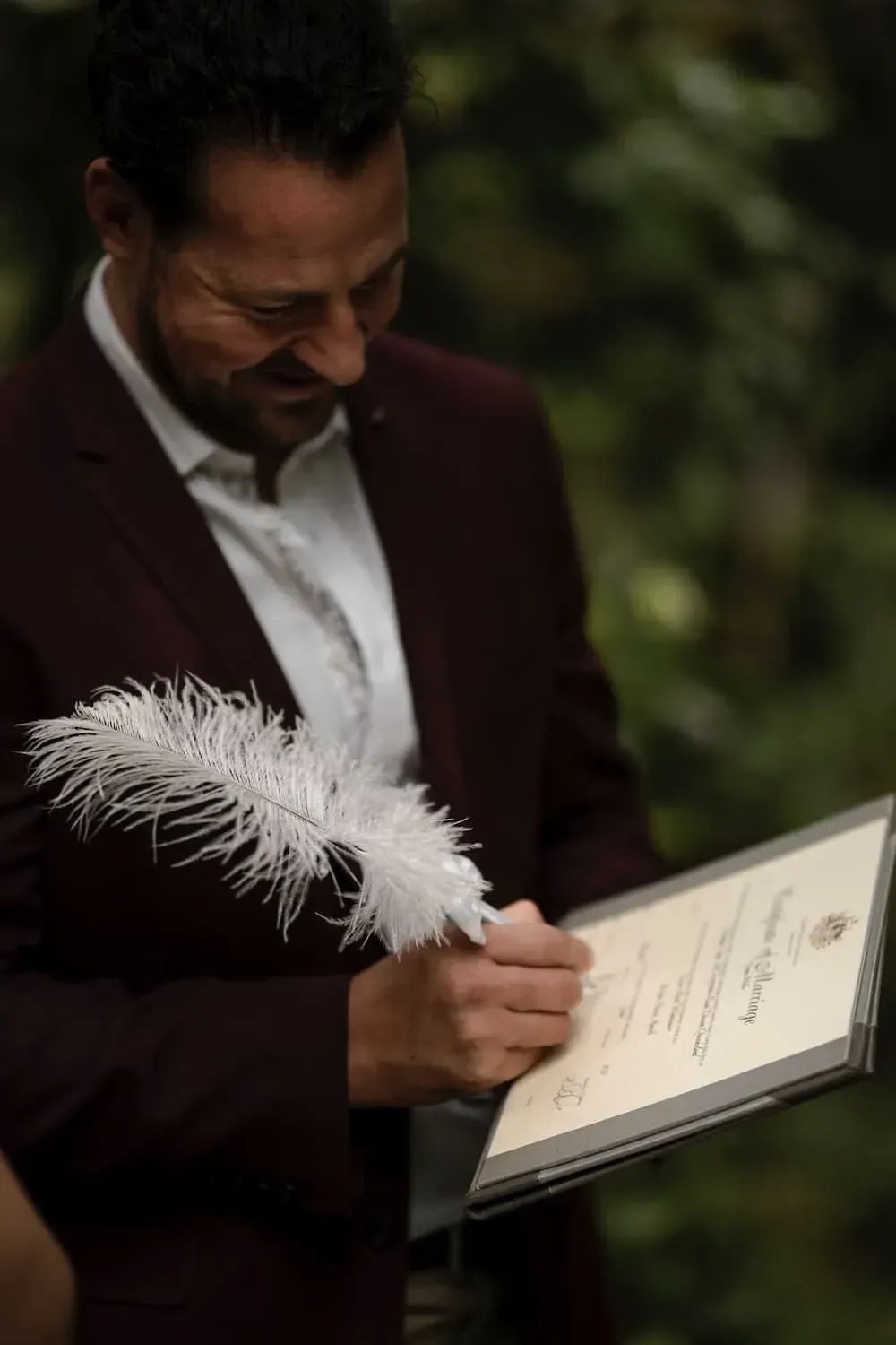A Man in a Suit is Writing on a Piece of Paper With a Feather โ GinaS Cairns Tropical Weddings in Parramatta Park, QLD
