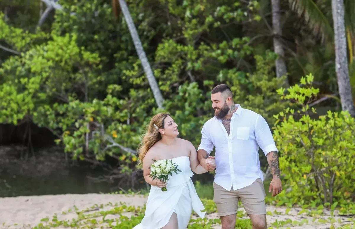 A Bride and Groom Are Walking on the Beach Holding Hands โ GinaS Cairns Tropical Weddings in Parramatta Park, QLD