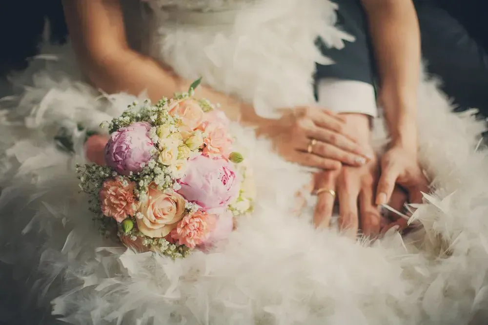 A Bride and Groom Are Holding Hands and a Bouquet of Flowers — GinaS Cairns Tropical Weddings in Parramatta Park, QLD