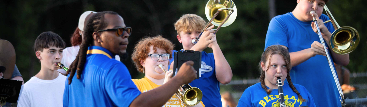 A group of young people are playing instruments in a band.