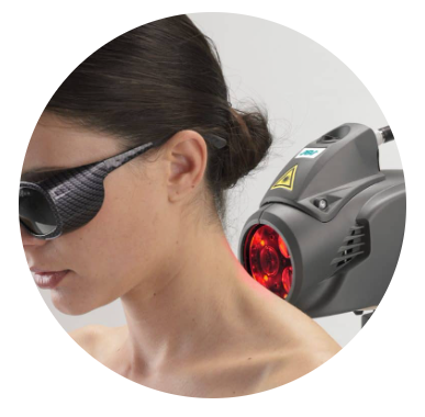 Woman wearing protective goggles near a red laser therapy device on her neck
