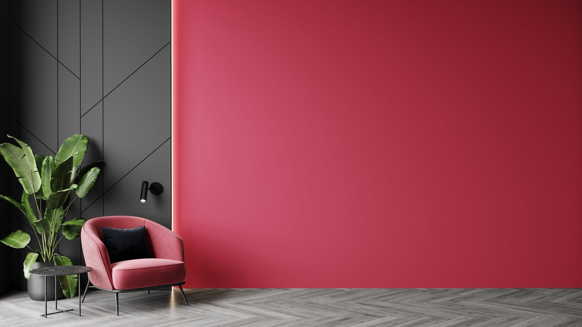 A modern room with a vibrant pink wall, a gray geometric-patterned wall, a velvet pink chair, and a potted plant.
